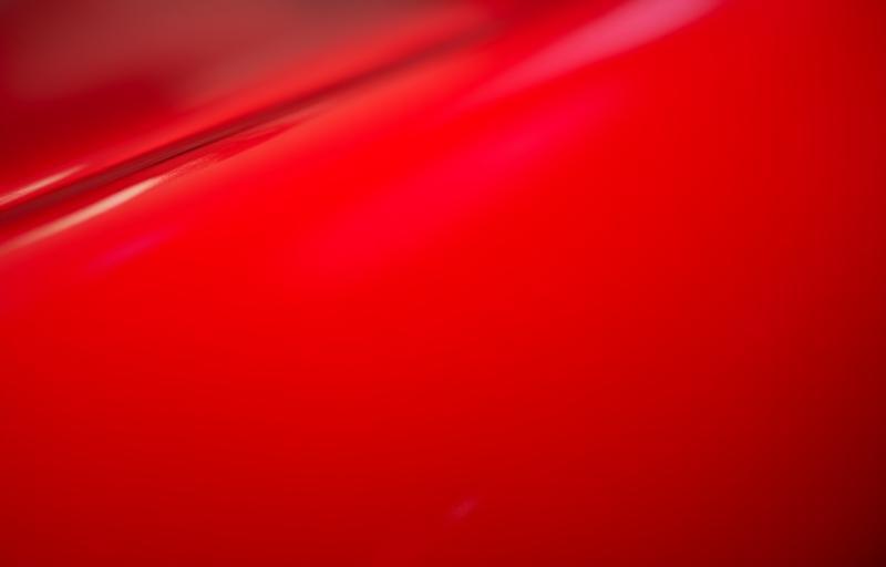 Glossy finish on a red car protected with paint protection film