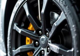 Close up of a car wheel and tire being cleaned